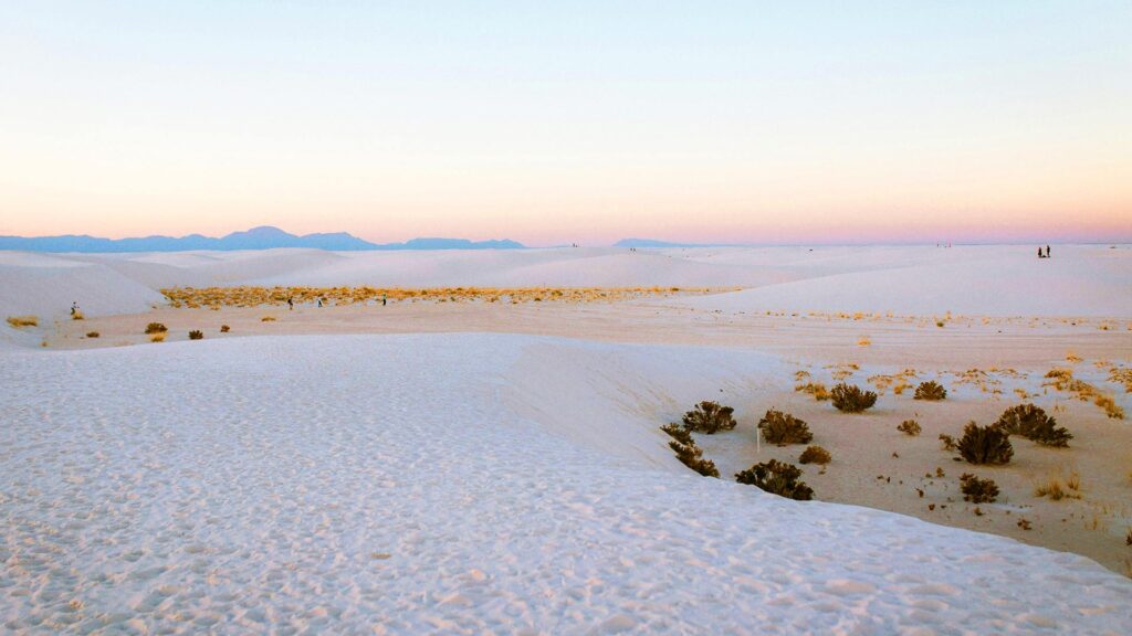 Expansive white gypsum dunes under a pastel sky at White Sands National Park, a surreal and lesser-known hidden US destination in New Mexico.