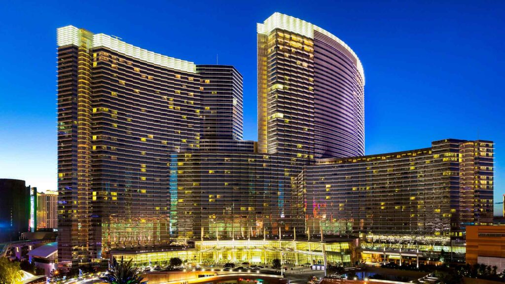 A dazzling night view of the Aria Resort & Casino in Las Vegas, showcasing its modern architecture and bright lights, making it a standout among luxury hotels in Las Vegas.