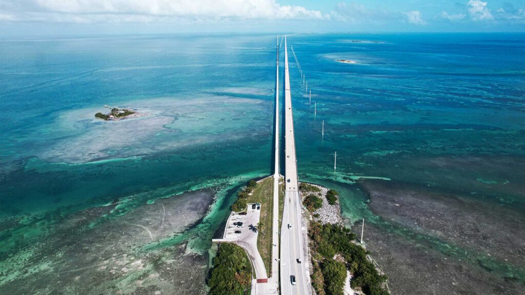 Aerial view of Florida Highway 1 stretching over turquoise waters toward the Florida Keys, showcasing one of the most iconic coastal road trips in USA.