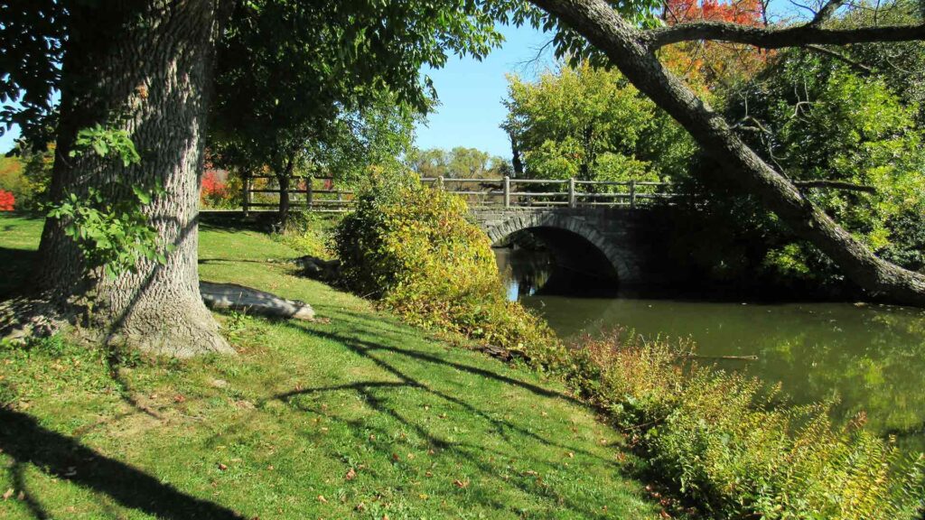 Peaceful park and stone bridge in Wisconsin Dells, a top destination for affordable family vacations in the Midwest.