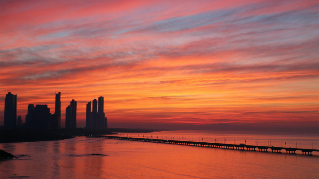 A stunning sunset view over Panama City Beach hotels and skyline, showcasing modern beachfront resorts against a colorful evening sky.
