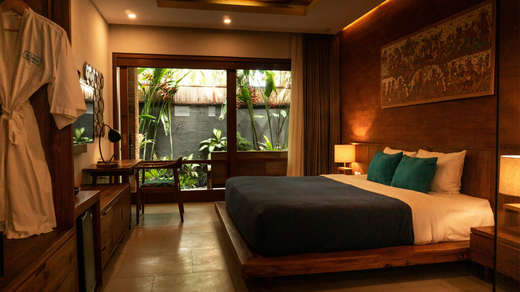 Cozy budget hotel room with modern decor and garden view – ideal for travelers seeking cheap stays in USA.