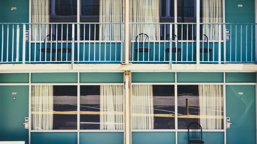 Classic roadside motel with simple rooms and balcony seating, perfect for budget-friendly cheap stays in USA.