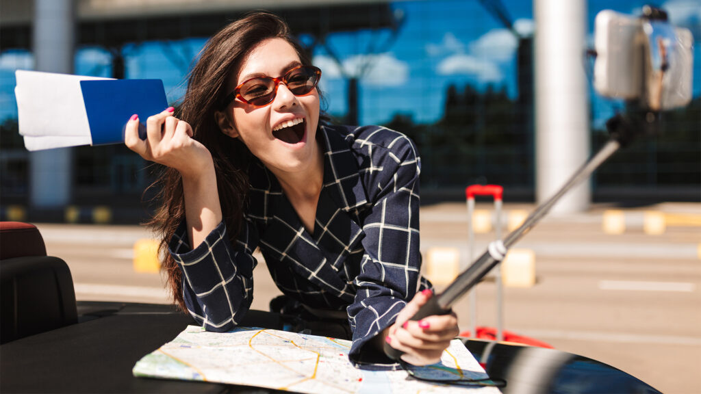 A woman at the airport, holding her passport and map, excited for her upcoming vacation.