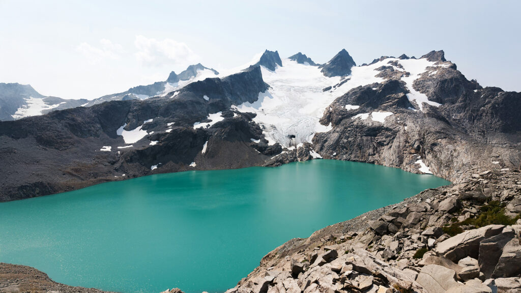 The stunning glacier lake surrounded by snowy mountains, a perfect destination for winter adventures among the best places to visit in December in the US.