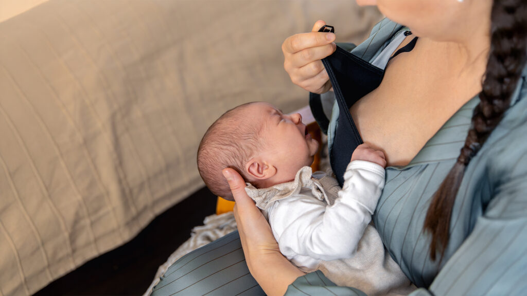 A mother nursing her newborn while flying. Tips on feeding your baby on a flight.