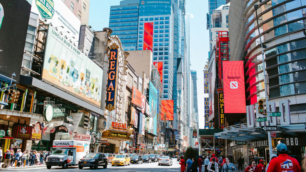Times Square with bright billboards, traffic, and crowds in New York City