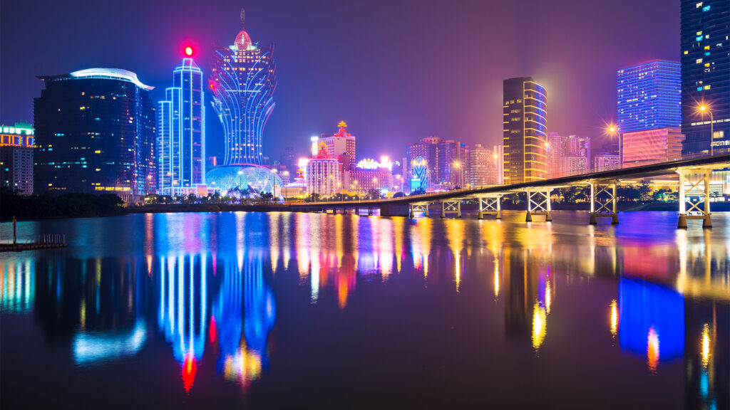 The dazzling skyline of Macau at night, showcasing the city's lights and luxurious casinos, rivaling Las Vegas as a major gambling destination.