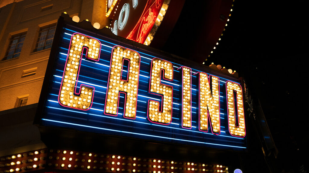 A bright and colorful casino marquee sign, representing the vibrant nightlife and gaming options in Las Vegas and Macau.