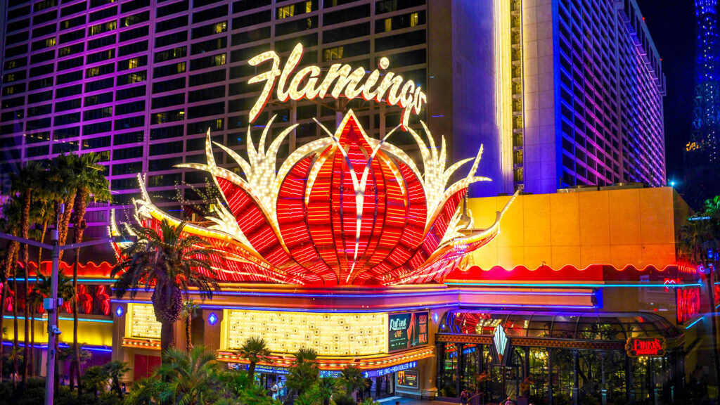 The iconic Flamingo hotel sign in Las Vegas, illuminated with bright lights, symbolizing the lively entertainment scene of the city.