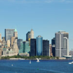 Statue of Liberty overlooking Manhattan skyline on a clear day