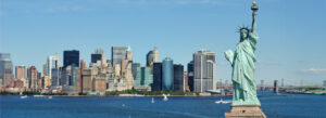 Statue of Liberty overlooking Manhattan skyline on a clear day
