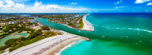 Scenic aerial view of Florida coastline during February, featuring turquoise waters and sandy beaches.