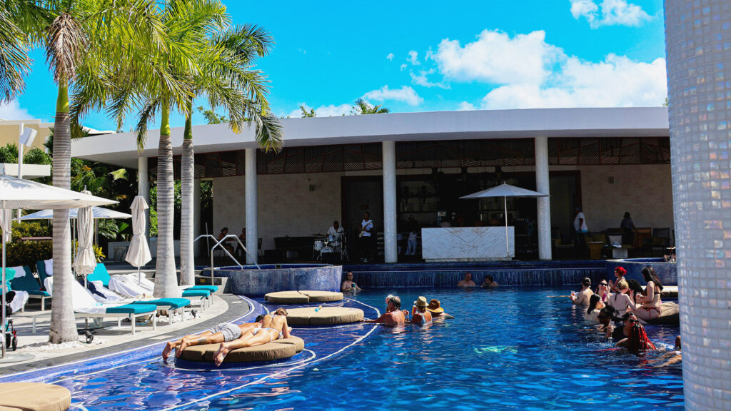 Swim-up bar at a Cancun resort, ideal for a fun and relaxing Cancun Summer Travel experience.