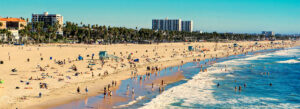 Venice Beach, California, featuring sunny sands and crowds enjoying the beach.