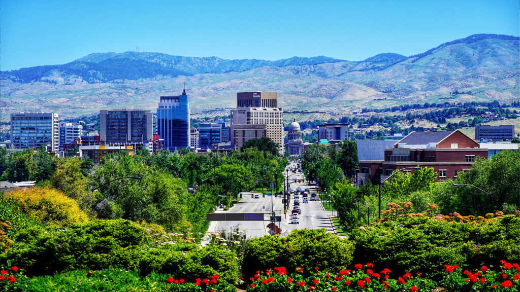 A vibrant cityscape with a mix of modern and natural beauty, showcasing an underrated summer destination with plenty to offer.