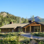 Rustic park lodge surrounded by pine forests and mountains, an ideal example of hotels near U.S. National Parks.