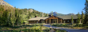 Rustic park lodge surrounded by pine forests and mountains, an ideal example of hotels near U.S. National Parks.