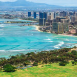 Panoramic view of Honolulu skyline, Waikiki Beach, and turquoise Pacific Ocean with Diamond Head in the background, one of the best coastal cities in America