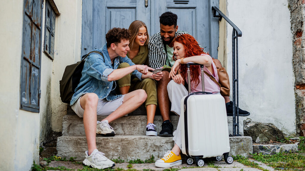 Group of friends enjoying their time together in a city, pointing out new spots to explore, a trend in the rise of short trips.